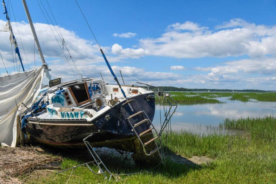 A sailboat with a sail port of Long Island, New York barely visible on it’s transom sits on the bank of Skull Creek on May 20, 2026 photographed off Jenkins Island near Hilton Head Island.