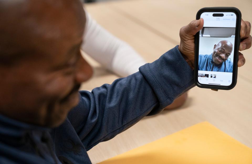 Albert Garrett, 60, a juvenile offender recently released after 44 years, checks out his first cellphone selfie on Monday, May 1, 2023,, at the State Appellate Defenders Office.