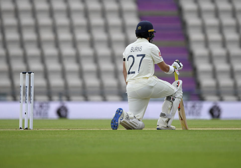 England's Rory Burns takes a knee on the first day of the 1st cricket Test match between England and West Indies, at the Ageas Bowl in Southampton, England, Wednesday July 8, 2020. (Mike Hewitt/Pool via AP)