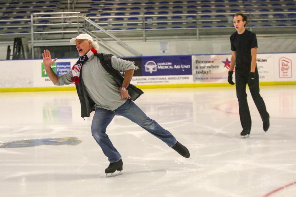 Coach Gary Irving (left) gives instruction during practice at the University of Delaware Fred Rust Ice Arena in December 2021.