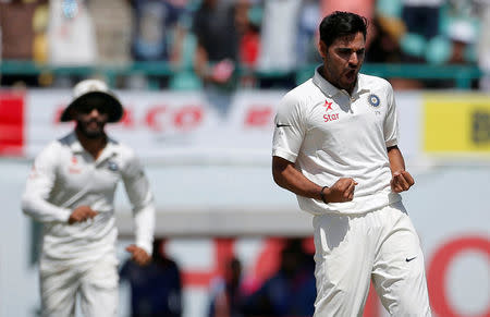 Cricket - India v Australia - Fourth Test cricket match - Himachal Pradesh Cricket Association Stadium, Dharamsala, India - 27/03/17 - India's Bhuvneshwar Kumar (R) celebrates after dismissing Australia's captain Steven Smith. REUTERS/Adnan Abidi