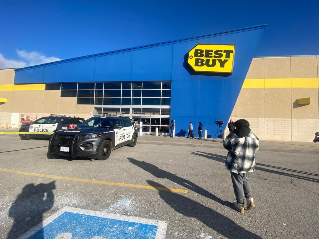 Toronto police vehicles parked outside a store in Scarborough after an off-duty officer was stabbed in the wrist on Wednesday. (Martin Trainor/CBC - image credit)