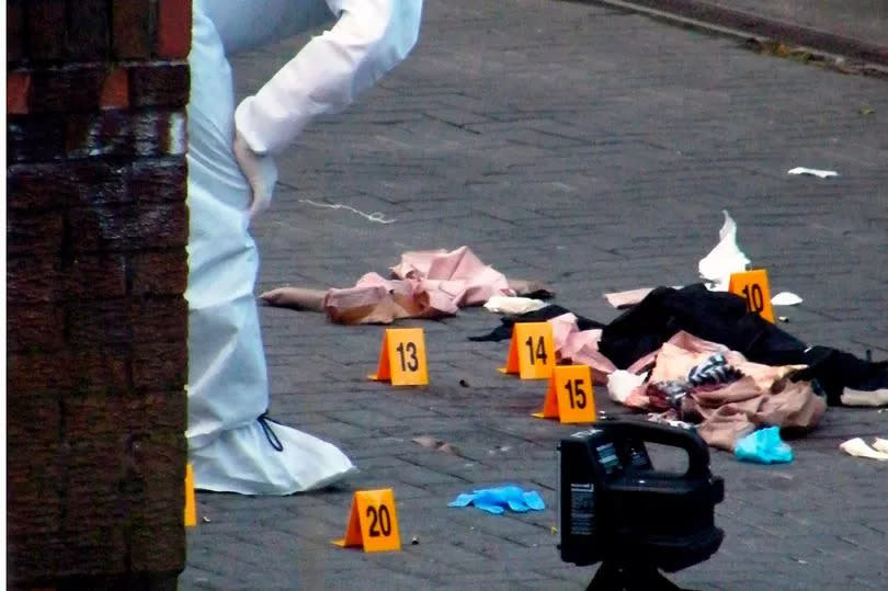 Forensic investigators at the scene in 2009 -Credit:Manchester Evening News.