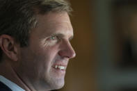 FILE - In this Thursday Sep., 26, 2019 file photo, Kentucky Attorney General and Democratic gubernatorial candidate Andy Beshear speaks with residents at Sayre Christina Village Senior Living Center in Lexington, Ky. While Democrats in Washington charge ahead with an impeachment inquiry, their party's candidates for governor in three Southern states are doing their best to steer the conversation away from Republican President Donald Trump and toward safer ground back home. (AP Photo/Bryan Woolston, File)