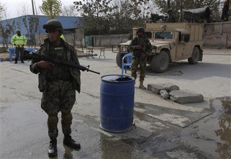 Afghan National Army (ANA) soldiers keep watch near a building in which the Loya Jirga (or grand council) is holding a committee session, in Kabul November 22, 2013. REUTERS/Omar Sobhani