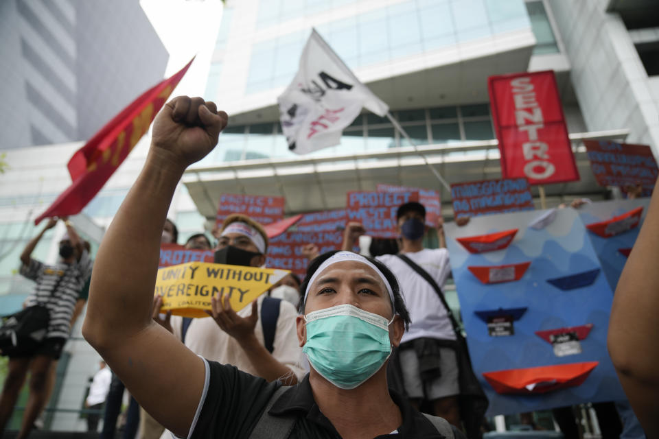 Protesters shout slogans to mark the 6th anniversary of the issuance of the 2016 decision by an arbitration tribunal set up under the U.N. Convention of the Law of the Sea after the Philippines complained against China's increasingly aggressive actions in the disputed sea during a rally outside the Chinese consulate in Makati, Philippines, Tuesday, July 12, 2022. U.S. Secretary of State Antony Blinken renewed a call to China to comply with a 2016 arbitration ruling that invalidated Beijing's vast claims in the South China Sea and warned that Washington is obligated to defend treaty ally Philippines if its armed forces, public vessels or aircraft come under attack in the disputed waters. (AP Photo/Aaron Favila)