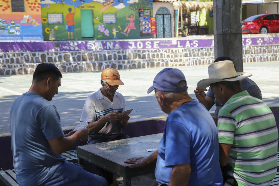 Residents play cards at the central park in San Jose Las Flores, El Salvador, Wednesday, Feb. 28, 2024. El Salvador held its mayoral elections on March 3. (AP Photo/Salvador Melendez)