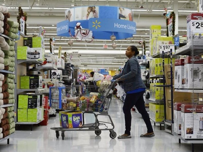 A customer pushes her shopping cart through the aisles at a Walmart store in the Porter Ranch section of Los Angeles November 26, 2013.  REUTERS/Kevork Djansezian