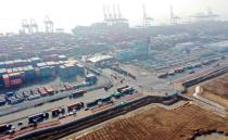 Trucks move into a port in Incheon, on the day truckers voted to end a nationwide strike