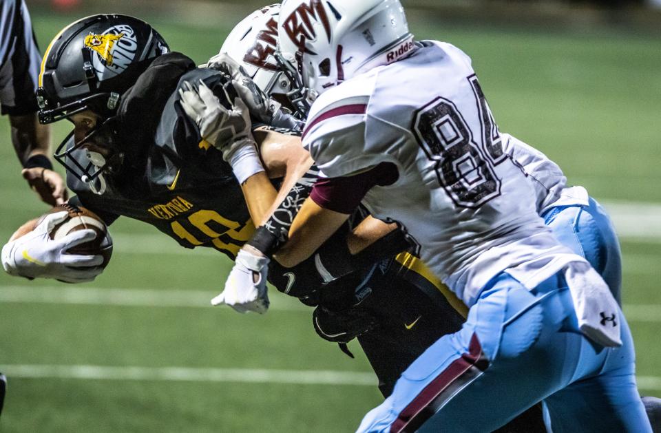 Ventura High's Tyler Woodworth is taken down by two Rancho Mirage defenders after making a catch during the Cougars' 35-19 home victory in a CIF-SS Division 9 quarterfinal on Friday, Nov. 12, 2021. Woodworth  finished with nine receptions for 150 yards.