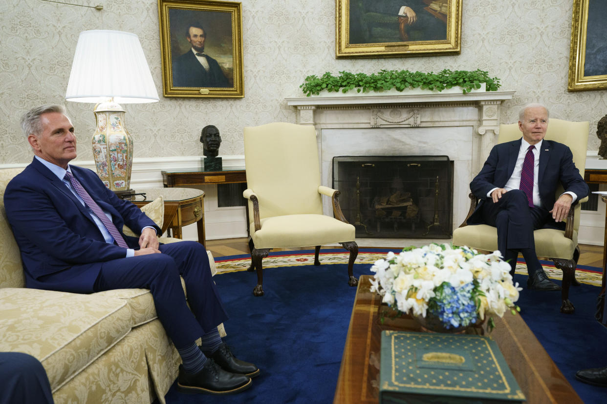 Speaker of the House Kevin McCarthy of Calif., left, listens as President Joe Biden speaks before a meeting on the debt limit in the Oval Office of the White House, Tuesday, May 9, 2023, in Washington. (AP Photo/Evan Vucci)