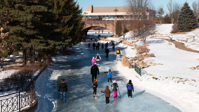 People ice skating on a frozen lake, Minnesota, USA.