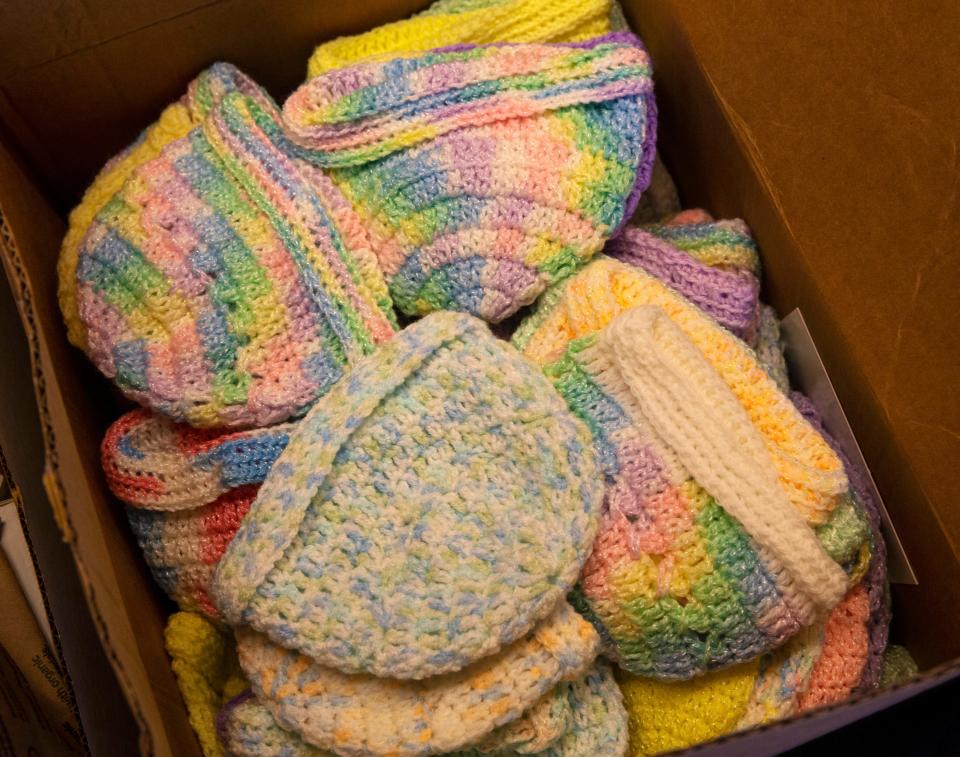 Betty O'Hearn delivers a box of crocheted hats to the Ronald McDonald House in Springfield.