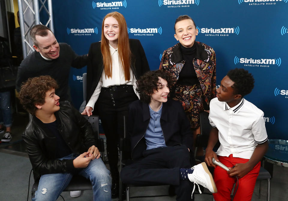 Some of the young cast members of "Stranger Things," pictured in November with host Sirius XM host Tim Stack, are getting rich. (Photo: Astrid Stawiarz via Getty Images)