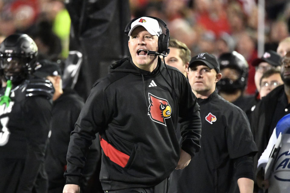 Louisville head coach Jeff Brohm shouts at his team during the first half of an NCAA college football game against Virginia in Louisville, Ky., Thursday, Nov. 9, 2023. (AP Photo/Timothy D. Easley)