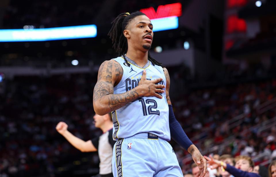 Memphis Grizzlies guard Ja Morant (12) reacts after scoring a basket during the first quarter against the Houston Rockets at Toyota Center.