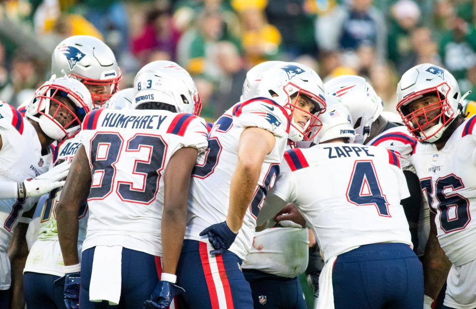 The New England Patriots huddle up to try to hear their quarterback Bailey Zappe (4) in the second half of the game against Green Bay Packers on Sunday, Oct. 2, 2022, at Lambeau Field in Green Bay, Wis. Samantha Madar/USA TODAY NETWORK-Wis.