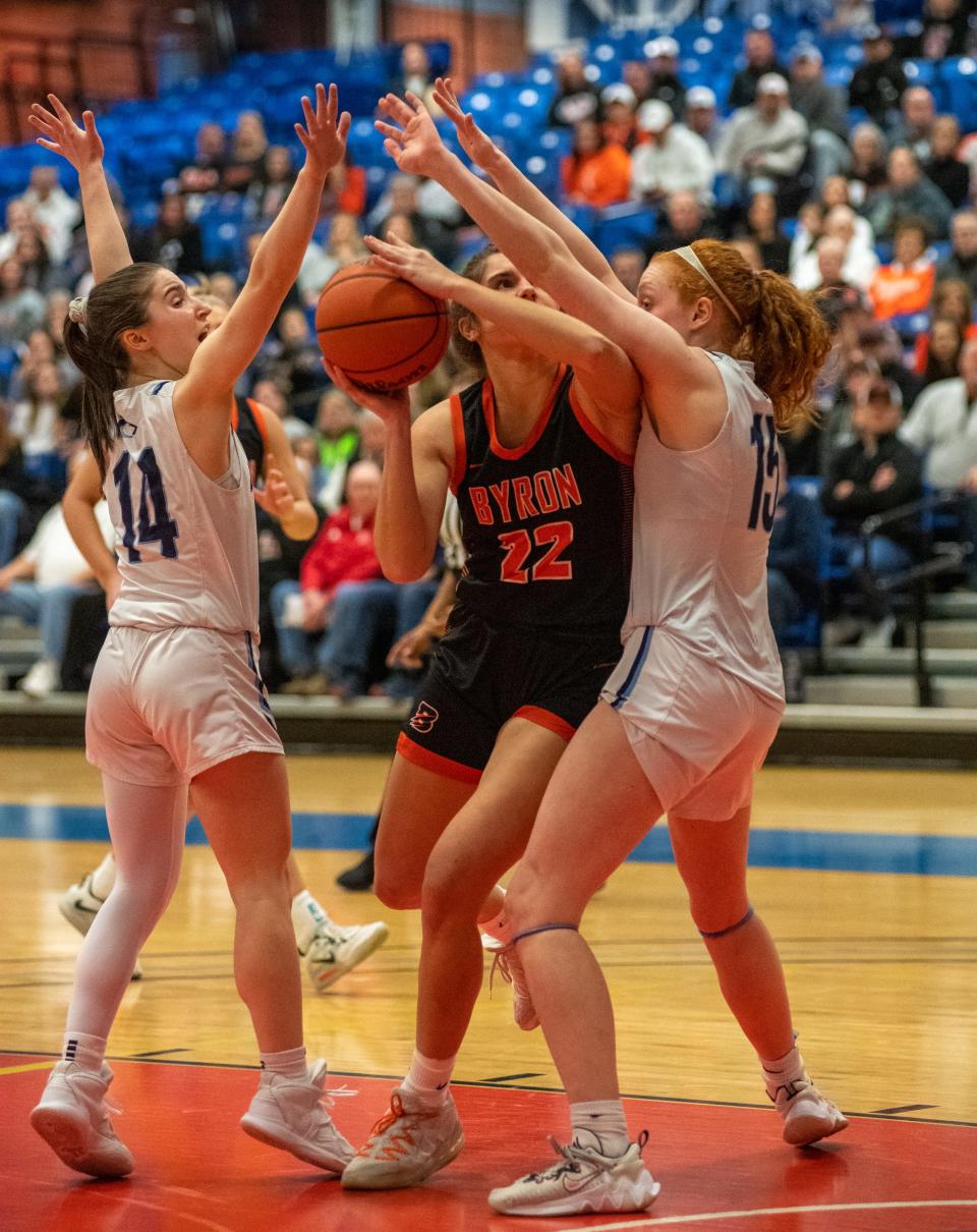 Byron's Ava Kultgen tries to put up a shot through the DePaul College Prep defense of Jadyn Kosanic, left, and Nora Leadstrom in the first quarter of the Elgin Supersectional game in Elgin on Monday, Feb. 27, 2023.
