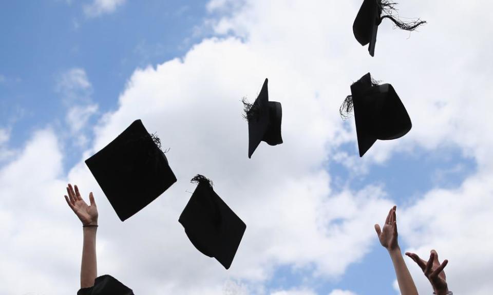 Graduates throw mortar boards