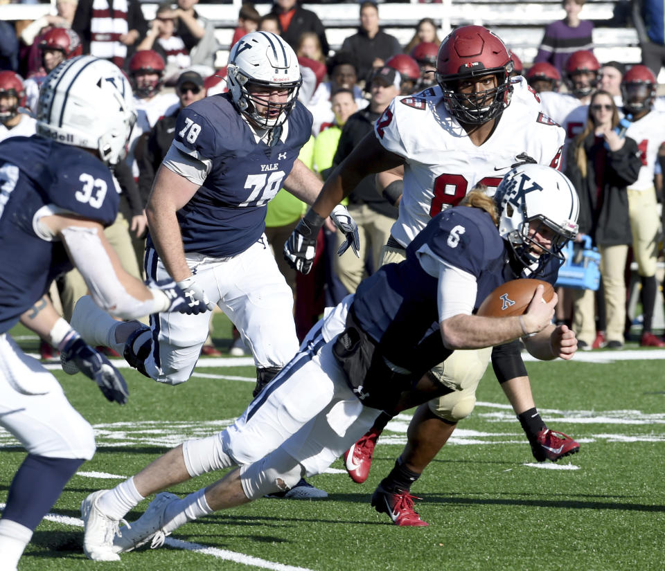 Yale quarterback Kurt Rawlings attempts to get a first down against Harvard during the first half during an NCAA college football game, Saturday, Nov. 23, 2019, in New Haven, Conn. (Arnold Gold/New Haven Register via AP)