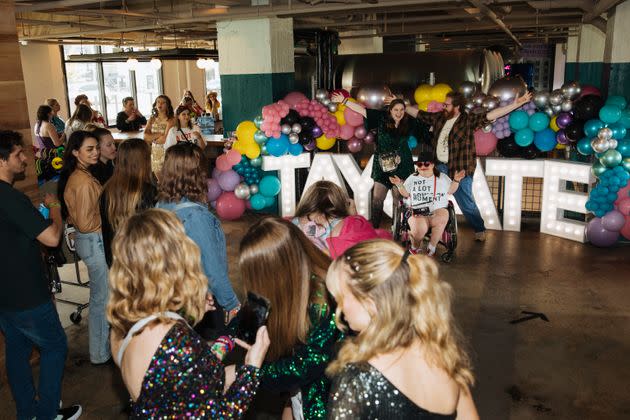 Taylor Swift fans wait to pose for a photo at Tay-gate, a tailgate party a short walk from the singer's shows in Atlanta.