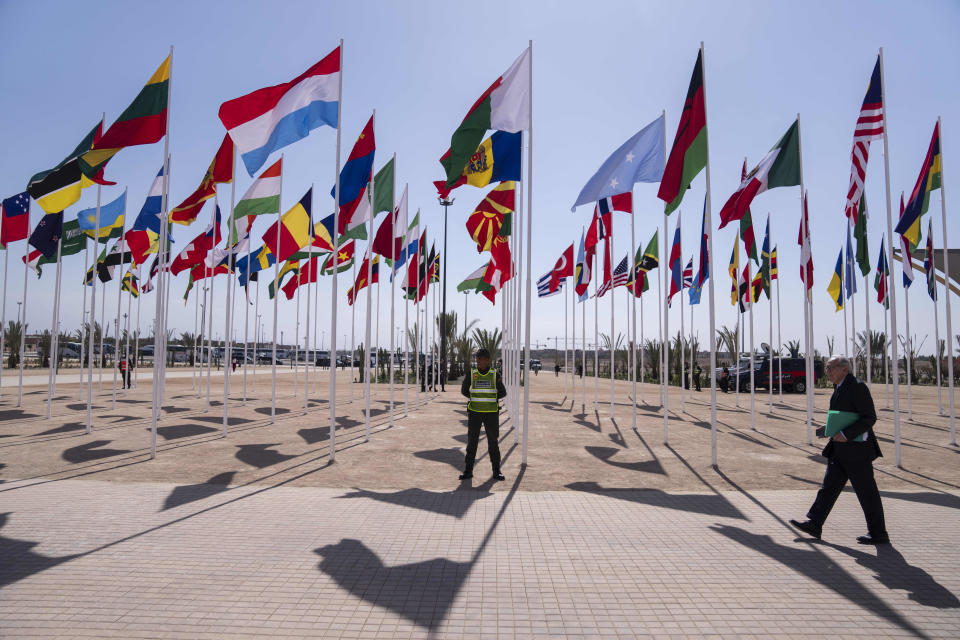 File - A member of the security forces stands guard outside a convention center hosting the IMF and World Bank annual meetings, in Marrakech, Morocco, Monday, Oct. 9, 2023. Some leaders suggested that this week's meetings of the International Monetary Fund and the World Bank in Marrakech, Morocco, would be "a good place to start" a conversation about Africa's financial challenges and its ability to handle climate shocks. (AP Photo/Mosa'ab Elshamy, File)