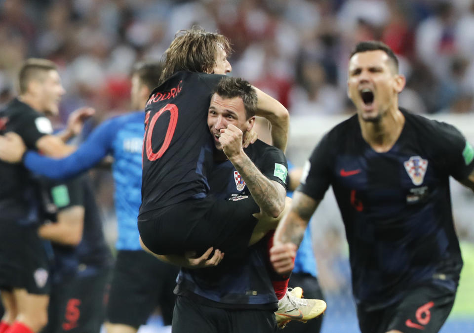 Croatia’s Mario Mandzukic, center, carries Luka Modric when celebrating after his team advanced to the final during the semifinal match between Croatia and England at the 2018 soccer World Cup in the Luzhniki Stadium in Moscow, Russia, Wednesday, July 11, 2018. (AP Photo/Frank Augstein)