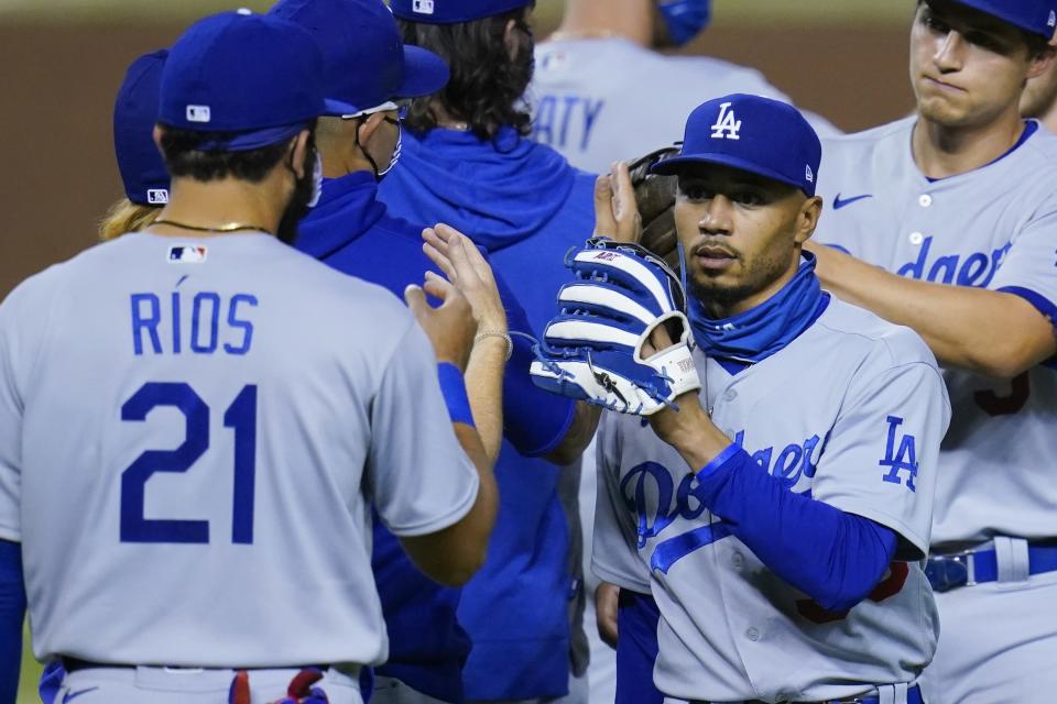 Los Angeles Dodgers' Mookie Betts, right, celebrates with Edwin Rios (21) and others after the Dodgers' 6-4 win over the Arizona Diamondbacks in 10 innings in a baseball game Wednesday, Sept. 9, 2020, in Phoenix. (AP Photo/Ross D. Franklin)