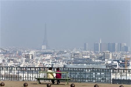 A general view shows the Eiffel tower and the Paris skyline through a small-particle haze from the Parc de St-Cloud, near Paris March 13, 2014 as warm and sunny weather continues in France. Residents and visitors to Paris basking in a streak of unseasonable sunshine were also being treated with a dangerous dose of particles from car fumes that pushed air pollution to levels above other northern European capitals this week. REUTERS/Charles Platiau