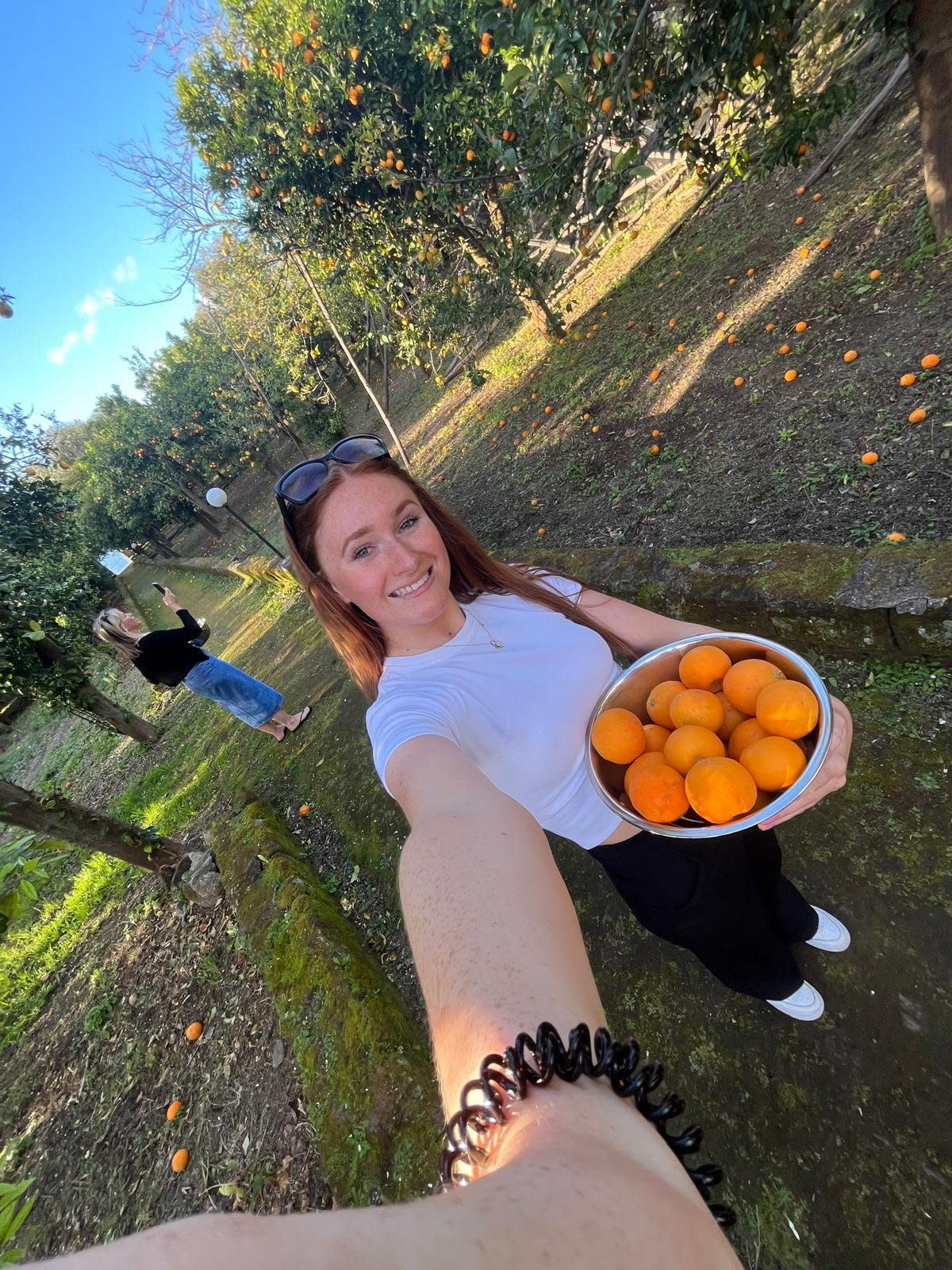 Brown collecting oranges in Italy. (Ella Brown/SWNS)