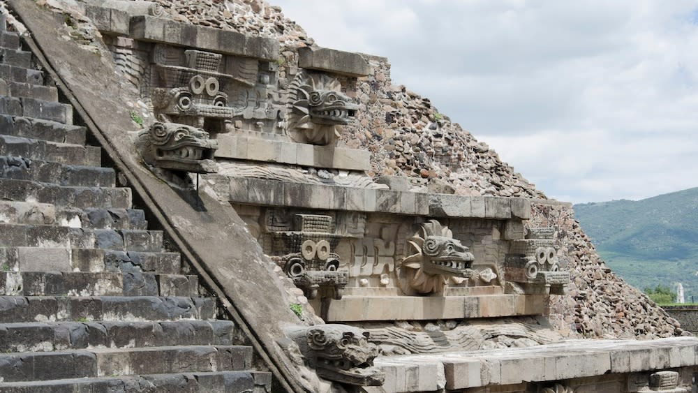  An ancient stone temple with carvings and stairs. 