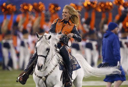 Anne Justice Wegener rides the Denver Broncos mascot, Thunder, onto the field before the start of the NFL Super Bowl XLVIII football game against the Seattle Seahawks in East Rutherford, New Jersey, February 2, 2014. REUTERS/Eduardo Munoz