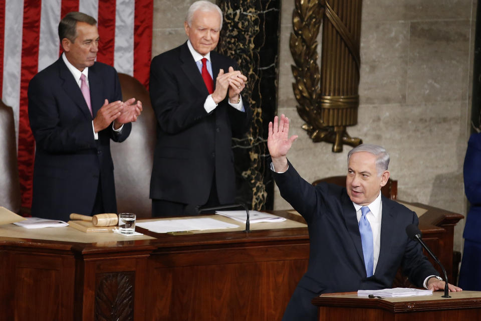 Israeli Prime Minister Benjamin Netanyahu waves as he steps to the lectern prior to speaking before a joint meeting of Congress on Capitol Hill in Washington on March 3, 2015. House Speaker John Boehner of Ohio, left, and Sen. Orrin Hatch (R-Utah) applaud. 