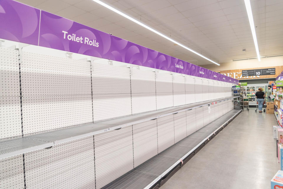 A view of Empty toilet roll shelves at a supermarks