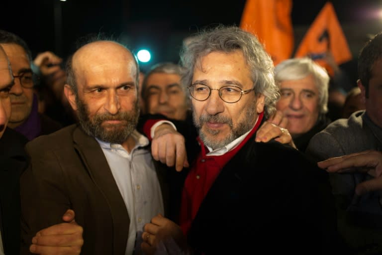 Turkish opposition journalists Erdem Gul (left) and Can Dundar talk to reporters after being freed from Silivri prison in Istanbul, on February 26, 2016