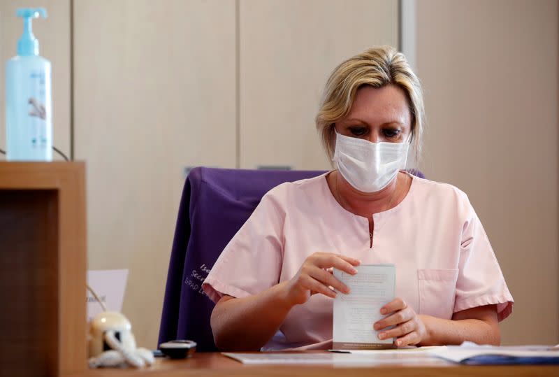 A health worker wears a protective face mask as she works at La Roseliere retirement home (EHPAD) in Kunheim