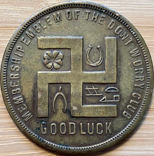 In this photo provided by Holocaust researcher Jeff Kelman in November 2022, the swastika is seen on a coupon-type store token made before the Nazi Party adopted the symbol. This is part of Kelman's collection, which he says shows the "regular and innocuous use of the swastika as a symbol of good fortune in the West, prior to the Nazi use of the similar-looking hakenkreuz." (Jeff Kelman via AP)