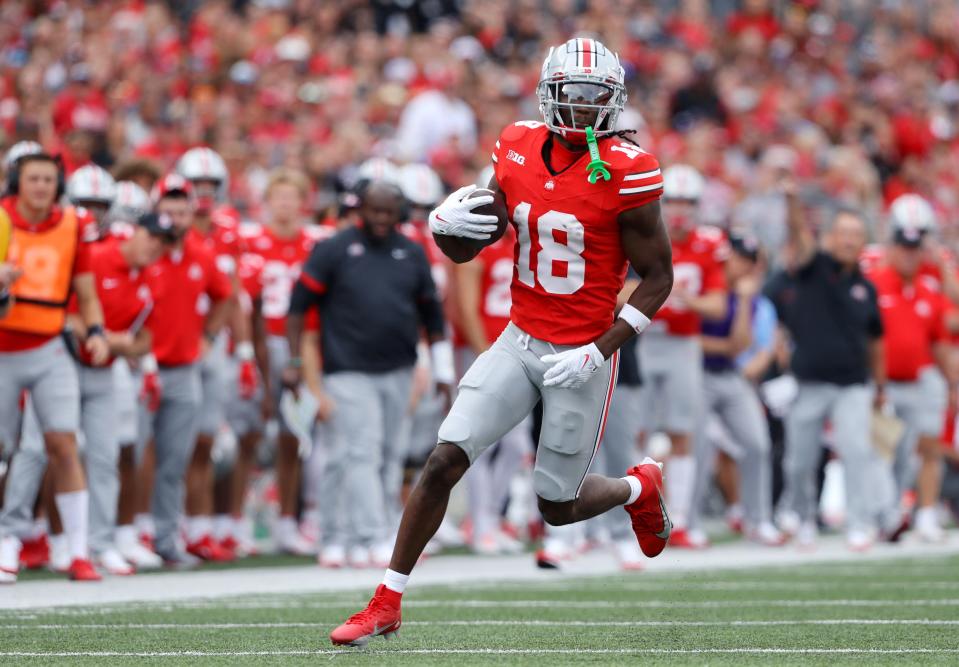 Sep 16, 2023; Columbus, Ohio, USA; Ohio State Buckeyes wide receiver Marvin Harrison Jr. (18) runs after the catch during the first quarter against the Western Kentucky Hilltoppers at Ohio Stadium. Mandatory Credit: Joseph Maiorana-USA TODAY Sports ORG XMIT: IMAGN-712057 ORIG FILE ID: 20230916_djc_mb3_093.JPG