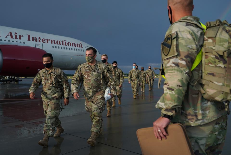 U.S. Army soldiers disembark from a plane upon arrival in Poznan, Poland, July 16, 2020. The Polish government expressed its willingness to host more U.S. troops.