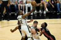 Milwaukee Bucks forward Khris Middleton (22) shoots over Miami Heat center Bam Adebayo (13) during the second half of Game 4 of an NBA basketball first-round playoff series, Saturday, May 29, 2021, in Miami. (AP Photo/Lynne Sladky)