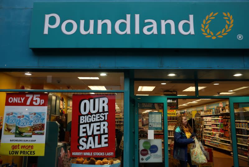 FILE PHOTO: A woman leaves a branch of Poundland in Altrincham, Britain