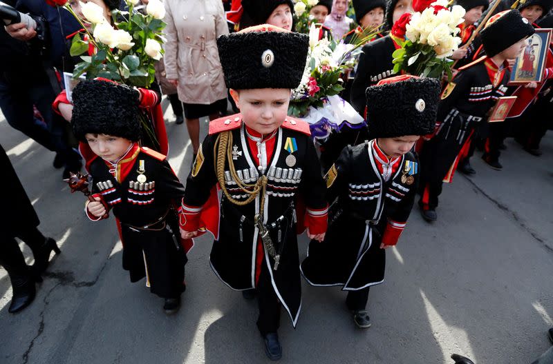 FILE PHOTO: Children take part in a religious procession to mark the Palm Sunday in St. Petersburg