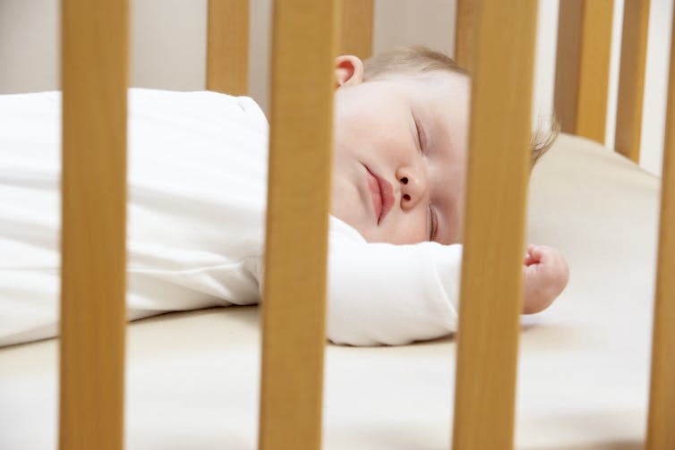 Baby sleeping in cot