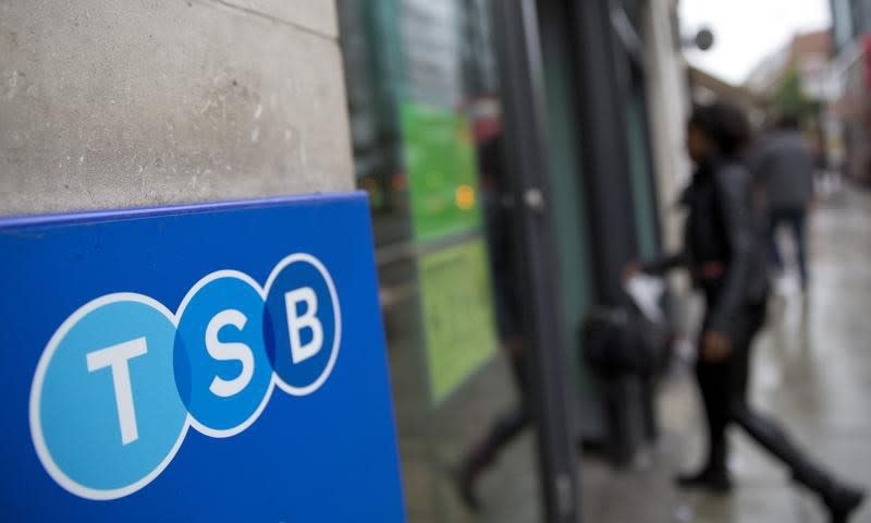 A woman wlalks into a branch of TSB bank in London May 27, 2014. REUTERS/Neil Hall