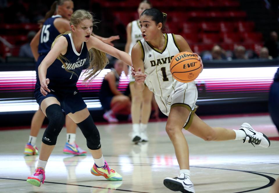 Davis High School’s T’Maea Eteuati dribbles around Corner Canyon’s Kenzie Randall during a 6A girls quarterfinal basketball game at the Huntsman Center in Salt Lake City on Monday, Feb. 26, 2024. Corner Canyon won 59-56 in overtime. | Kristin Murphy, Deseret News