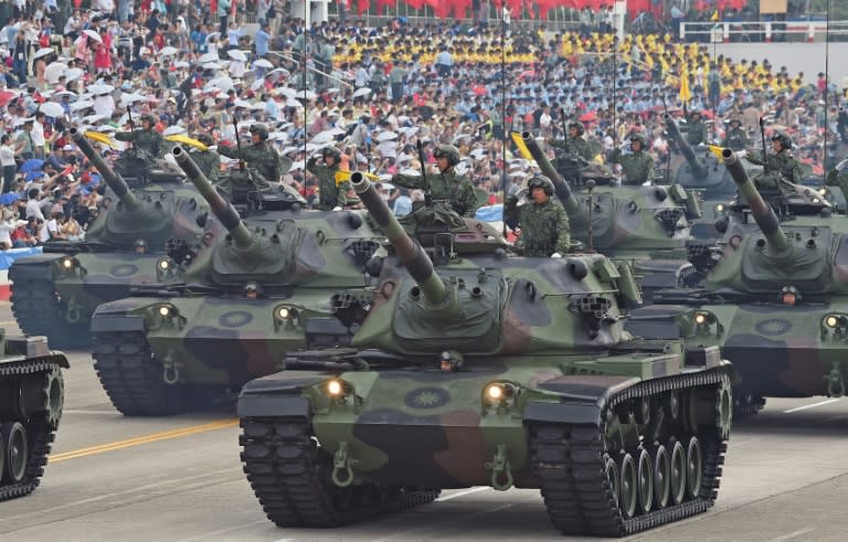 Soldiers salute from the M60A3 tanks during the 70th Anniversary of the WWII at the Huko military in northern Hsinchu, Taiwan on July 4, 2015