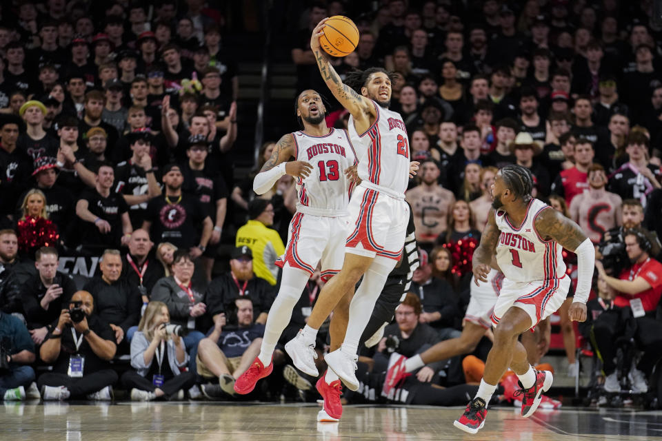 Houston guard Emanuel Sharp, center, catches a rebound during the second half of an NCAA basketball game against Cincinnati, Saturday, Feb. 10, 2024, in Cincinnati. (AP Photo/Joshua A. Bickel)