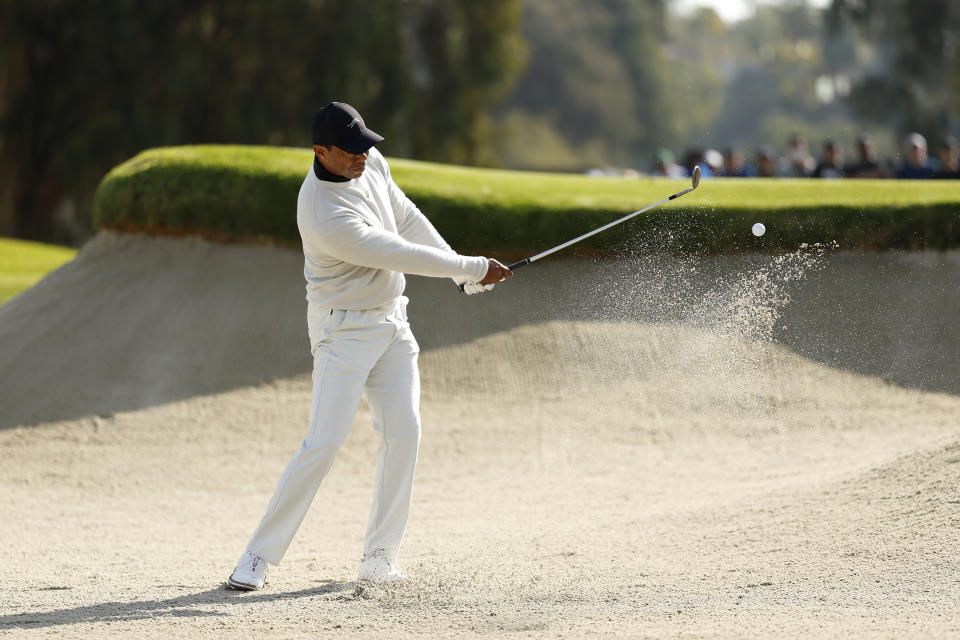 Tiger Woods hits from a bunker toward the third green during the first round of the Genesis Invitational golf tournament at Riviera Country Club, Thursday, Feb. 15, 2024, in the Pacific Palisades area of Los Angeles. (AP Photo/Ryan Kang)