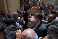 Reformist candidate for the Iran's presidential election Masoud Pezeshkian waves as he arrives to vote at a polling station in Shahr-e-Qods near Tehran, Iran, Friday, July 5, 2024. Iranians began voting Friday in a runoff election to replace the late President Ebrahim Raisi, killed in a helicopter crash last month, as public apathy has become pervasive in the Islamic Republic after years of economic woes, mass protests and tensions in the Middle East. (AP Photo/Vahid Salemi)