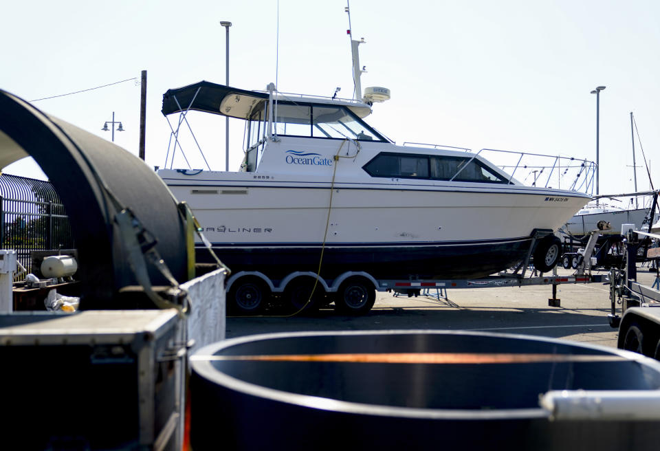 A boat with the OceanGate logo is parked on a lot near the OceanGate offices Thursday, June 22, 2023, in Everett, Wash. The U.S. Coast Guard said Thursday that the missing submersible Titan imploded near the Titanic shipwreck site, killing everyone on board. (AP Photo/Lindsey Wasson)